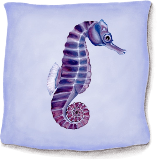 A purple and white seahorse pillow on top of a blue blanket.